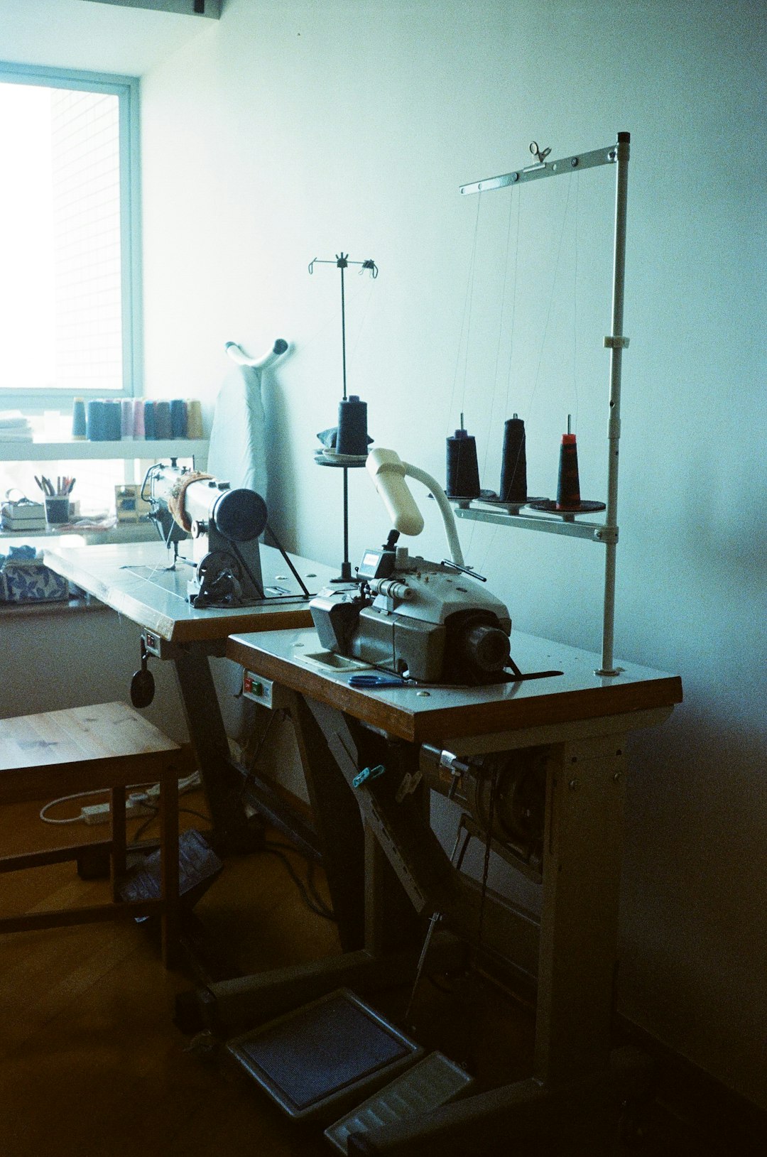 portfolio-02 a-sewing-machine-sitting-on-top-of-a-wooden-table-whkzbmq9hta